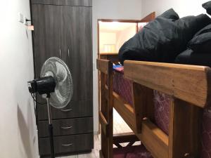 a room with a fan next to a bunk bed at Catamarca 4855 Fondo Izquierda in La Lucila del Mar