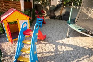 a playground with a play set and a swing at Villa Palma - With Free Parking in Mostar