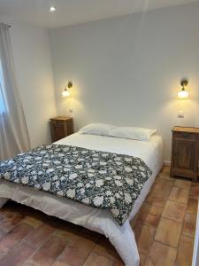 a bedroom with a bed with a blanket on it at Casa Scaledda in Bocognano