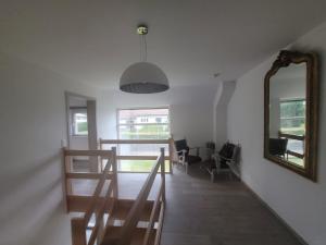 a living room with a mirror and a table and chairs at Welcome House in Spa
