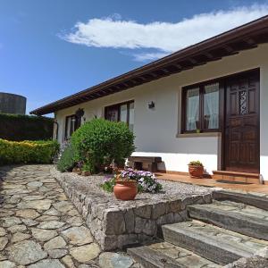 a house with a stone walkway in front of it at Las Candelas - La Canaleja in Oreña