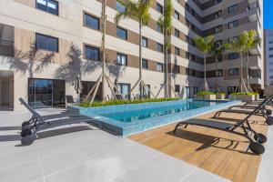 a swimming pool in the middle of a building at One House in Curitiba