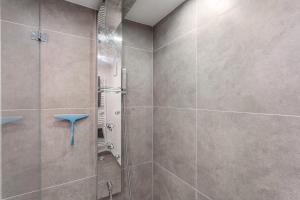 a bathroom with a shower with a glass door at Ferienwohnung Panoramanest in Balve +15 photos