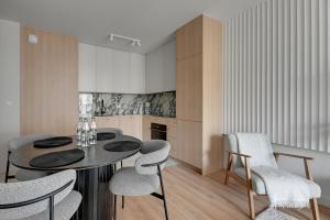 ein Esszimmer mit Tisch und Stühlen in der Unterkunft Horizon 63 Superior by Grand Apartments in Danzig