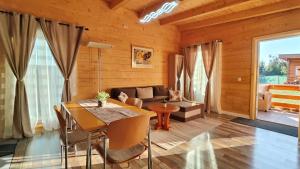 a living room with a table and a couch at Turda Retreat in Turda