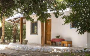 a table and bench in front of a house at Campement solidaire Nioko Bokk in Abémé