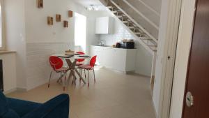 a kitchen with a table and chairs and a staircase at Stop and Fly in Naples