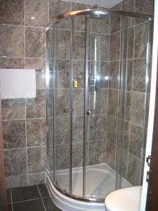 a shower with a glass door in a bathroom at Edinburgh House Hotel in Edinburgh