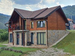 a house on a hill with at Kuća odmora Čarolija in Gostilje