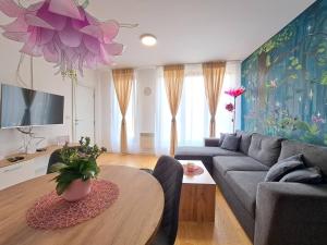 a living room with a couch and a table at Kuća odmora Čarolija in Gostilje