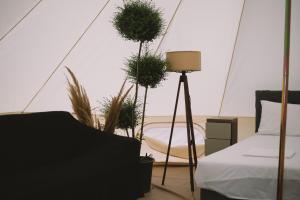 a room with a bed and potted plants in a tent at Glamping Neptun in Ulcinj +11 photos