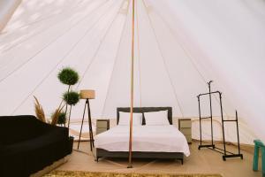 a bedroom with a bed in a tent at Glamping Neptun in Ulcinj