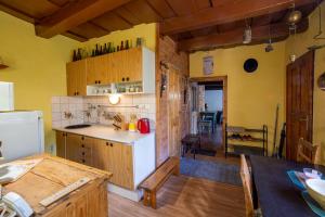 a kitchen with a white refrigerator and a table at Haviarsky dom PIARG in Štiavnické Bane