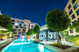 a swimming pool in front of a building at شقة استوديو فاخرة في الزاهية الشارقة - cozy Studio in Sharjah