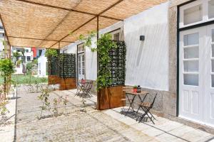 a patio area with a bench and a window at bnapartments Carregal in Porto