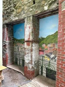 a mural of a city seen through two windows at Oasis Valley in Karlovy Vary