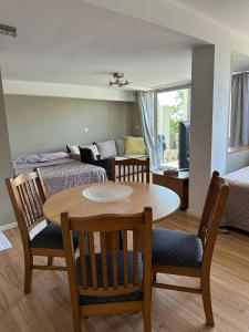 a room with a table and chairs and a living room at Lake & Mountain retreat in Lagadin, OHRID in Lagadin