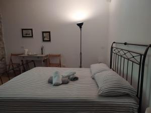 a bed with a stuffed animal laying on it at Casa del Vicolo in Ome