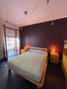 a bedroom with a bed with two lights on it at Casa vacanze Montaldo in Bordighera