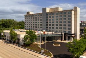 an aerial view of a building with a road in front at Hyatt Centric Chicago Ohare in Rosemont