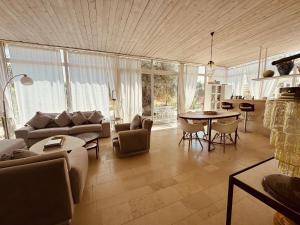 a living room with a couch and a table at Villa Il Carrubo val di noto con piscina privata in Avola