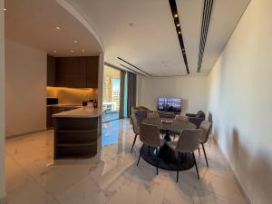 a kitchen and living room with a table and chairs at The 1 -Nicosia Luxe Stay- Gym Pool 24h Concierge in Nicosia