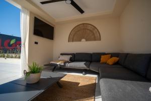 a living room with a couch and a table at Vacation House Privlaka in Privlaka +37 photos