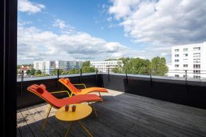 two chairs and a table on a balcony at sly Berlin in Berlin +97 photos