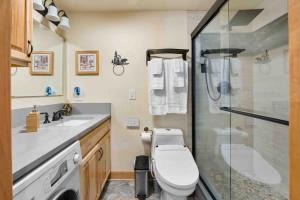 a bathroom with a toilet and a glass shower at TahoeCozy with Pool Hot Tub and Near Northstar in Tahoe Vista