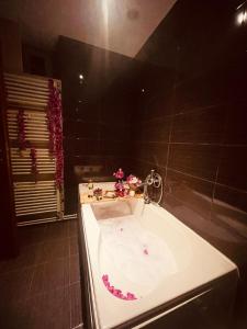 a bathroom with a bath tub in a room at City Tales Residence in Braşov +35 photos