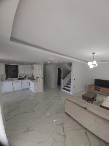 a large living room with a couch and a kitchen at Datcha Cozyvilla in Datca +8 photos