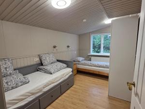 a room with two beds and a window at LL Properties - Spacious Family - Golden Circle in Úthlid