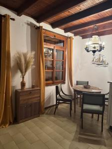 a dining room with a table and chairs and a window at Agora Serenity Retreat in Pythagoreio +24 photos