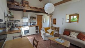 a living room with a couch and a table at Le Gîte du Bocage in Céaucé