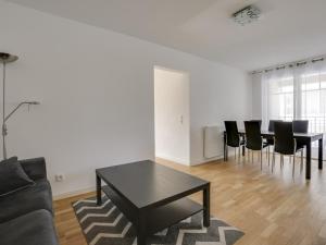 a living room with a black table and chairs at Appartement de standing 8 pers, hyper centre Arcachon, balcon, parking privé, proche plages et gare - FR-1-474-28 in Arcachon
