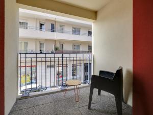a room with a piano and a chair in front of a building at Appartement de standing 8 pers, hyper centre Arcachon, balcon, parking privé, proche plages et gare - FR-1-474-28 in Arcachon +6 photos