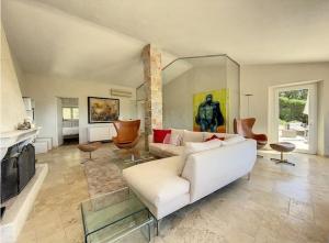 a living room with a white couch and a fireplace at Charming Villa with stunning sea views in Mougins