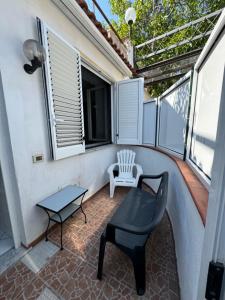 a small balcony with a chair and a table at case vacanza hoya in Lacco Ameno