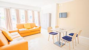 a living room with a couch and a table at Relais du Lac Village - Italian Homing in Desenzano del Garda