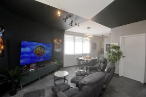 a living room with couches and a tv and a table at Studio 68, appartement 4personnes in Saint-Louis