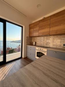 a kitchen with a large window with a view at Apartment Ivi, Omis in Omiš