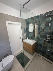 a bathroom with a toilet and a sink and a shower at Apartment Ivi, Omis in Omiš