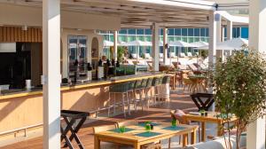 a view of a restaurant with tables and chairs at Rixos Premium Dubrovnik in Dubrovnik