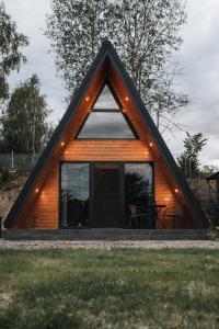 a small wooden house with a pitched roof at The DREAM A-frame Cabin in Arpaşu de Sus