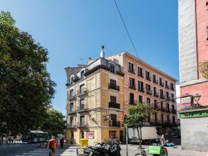 a tall building on the corner of a city street at Cottage & Vintage in Madrid