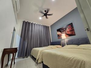 a bedroom with two beds and a ceiling fan at TropINN LoDonHeartBeat 5LuxRoom CirPool BBQ & KTVFun in Bandar Penawar