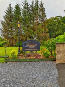 a sign in a park with a street light at Lakeside Lodge Retreat, with Roof Deck min 6 nights  +11 photos