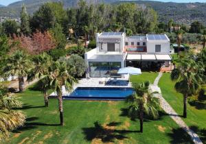an aerial view of a house with a swimming pool at Evia Palm Beach Villa in Politika