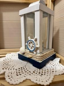a toy clock sitting on top of a table at Alba b&b in Polignano a Mare