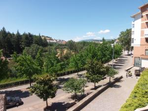 a street with trees in a parking lot next to a building at Loreto Apartment in Bragança